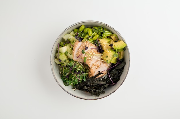 Asian style poke bowl with chicken and vegetables