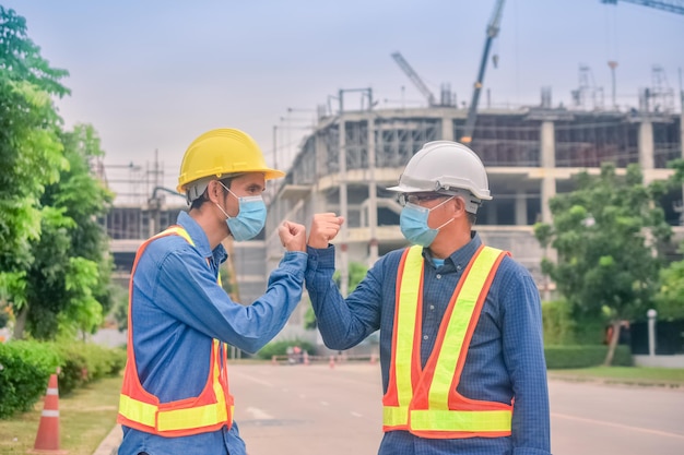 Asian team Construction engineers supervising progress of construction project stand on new factory Engineering Consulting People on construction site Building inspector