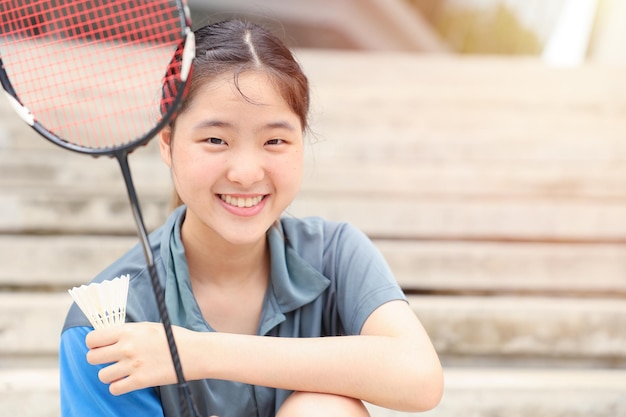 Asian Teen girl sport player with Badminton equipment for healthy outdoor portrait happy smile