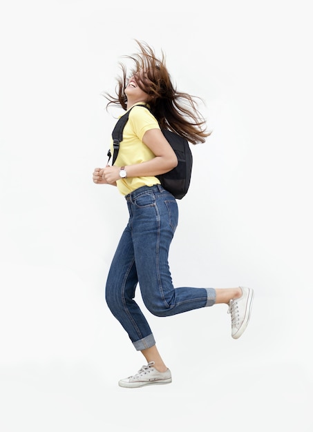 asian teenage girl jump ping with backpack