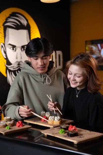 asian teens eating sushi