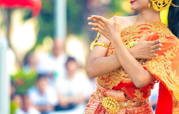 Asian Thai Female dresses the vintage traditional dress and dances with the Thai dance style at the outdoor in the event., Thailand