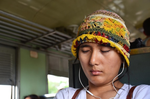 Asian thai women travelers people sit listen music and sleep
dream on locomotive train after travel visit phra nakhon si
ayutthaya between railway railroad running from ayutthaya to
bangkok thailand