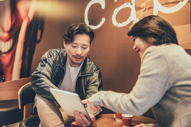 Asian tourist couple on a tablet