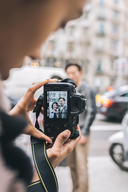 Asian tourist couple taking a picture with a camera