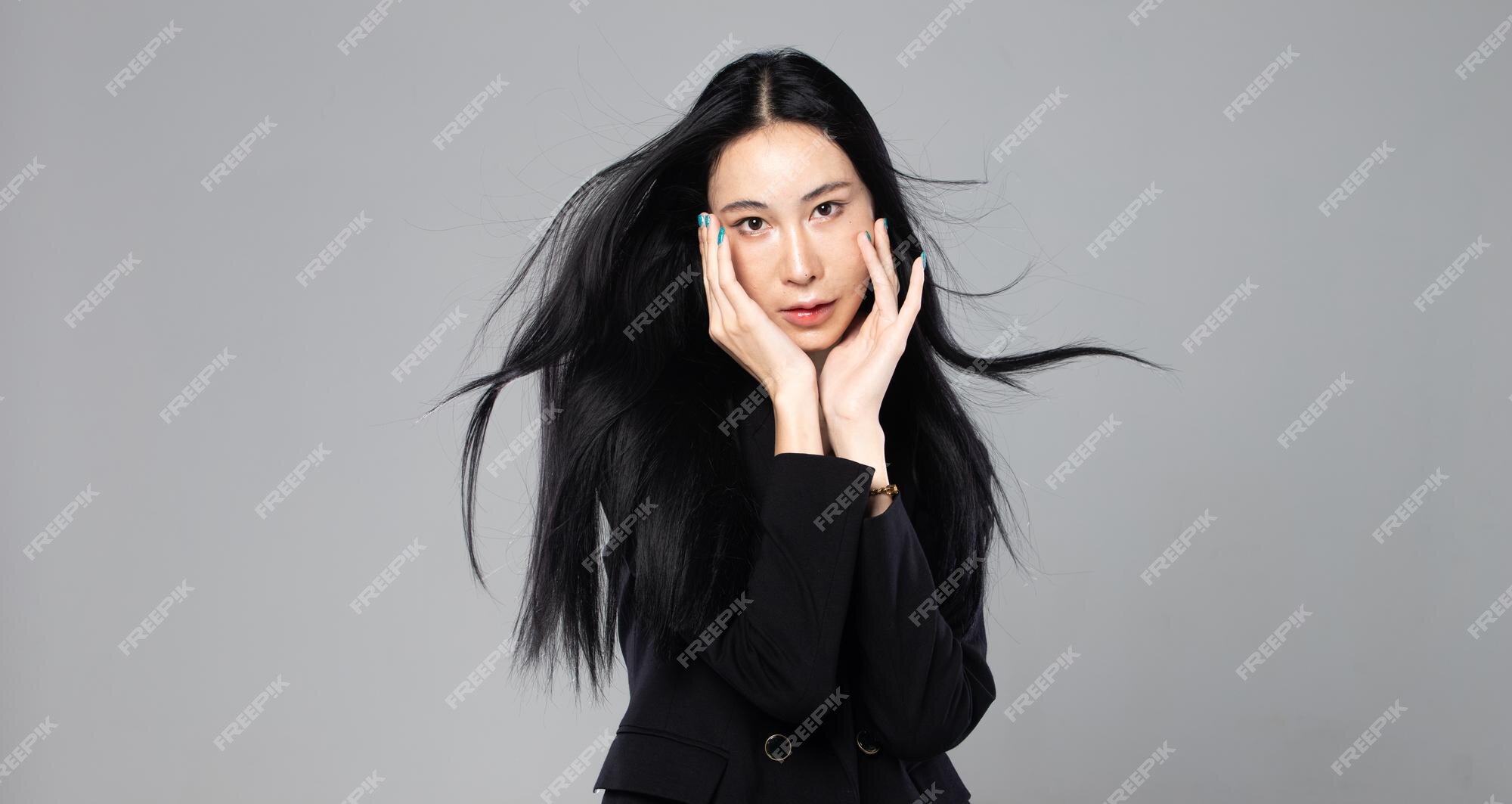 Premium Photo | Asian transgender woman with long black straight hair wind blow throw in the air female hold phone against wind storm feeling fashion sensual sexy gray background isolated copy space Premium Photo | Asian transgender woman with long black straight hair wind blow throw in the air female hold phone against wind storm feeling fashion sensual sexy gray background isolated copy space