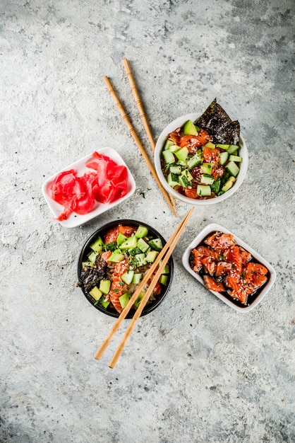 Asian trendy food, sushi poke bowl with cucumber, salmon, avocado