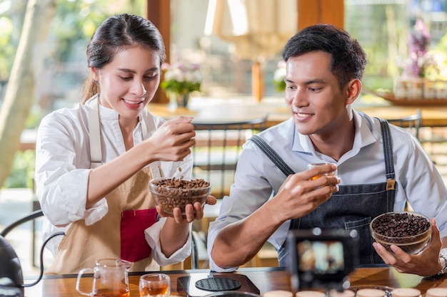 Asian two partner of small business owner showing and presenting the how to making coffee