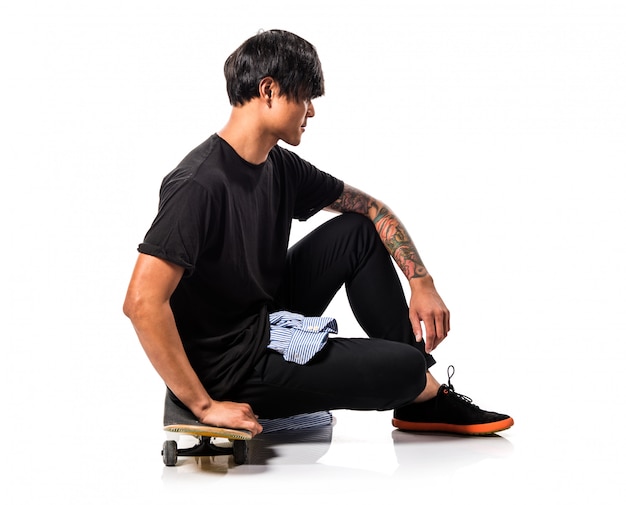 Asian urban man with skate