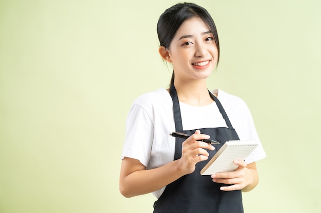 Asian waitress holding a note in hand