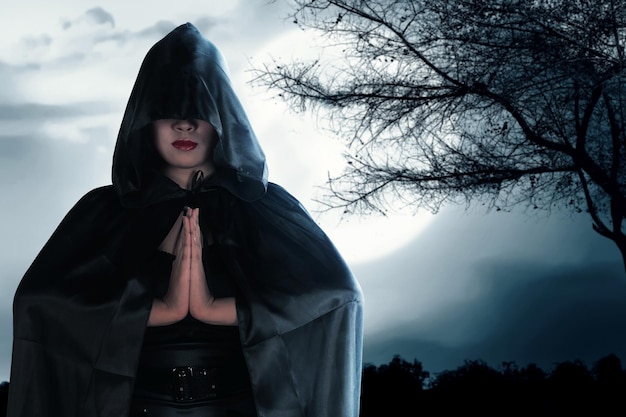 Asian witch woman with a cloak standing