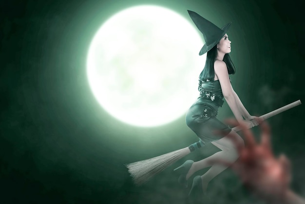 Asian witch woman with hat flying on a magic broomstick