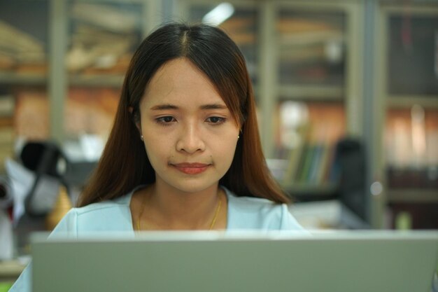 Asian woman analyzing computer work plan