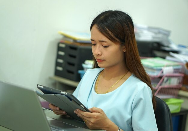 Asian woman analyzing computer work plan