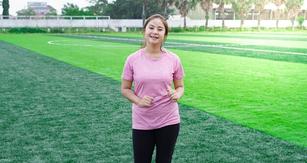 Asian woman athlete running on track