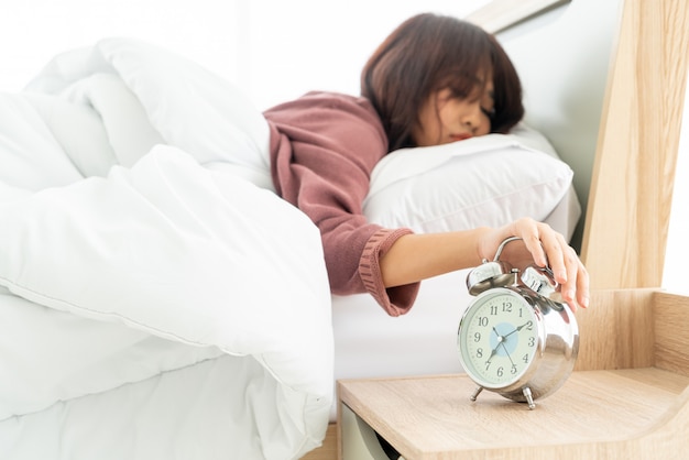 Asian woman on bed and waking up in the morning