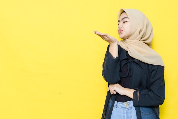 Asian woman blows palms with empty space.