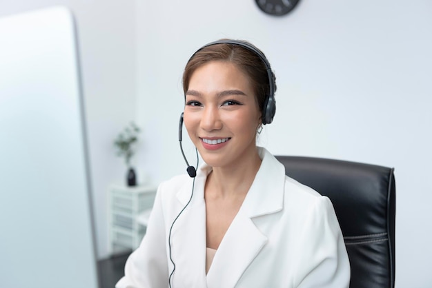 Asian woman Call center agent with headset working on support hotline in modern office