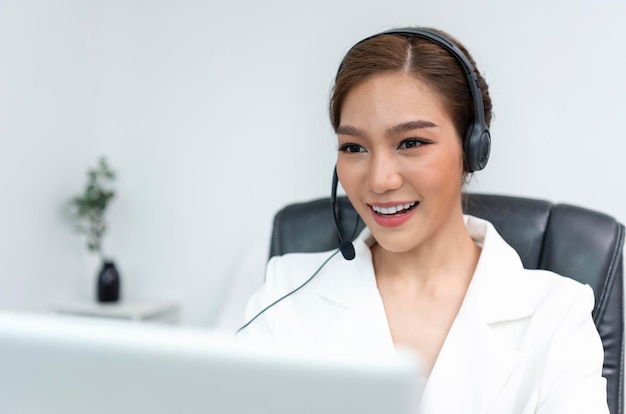 Photo asian woman call center agent with headset working on support hotline in modern office