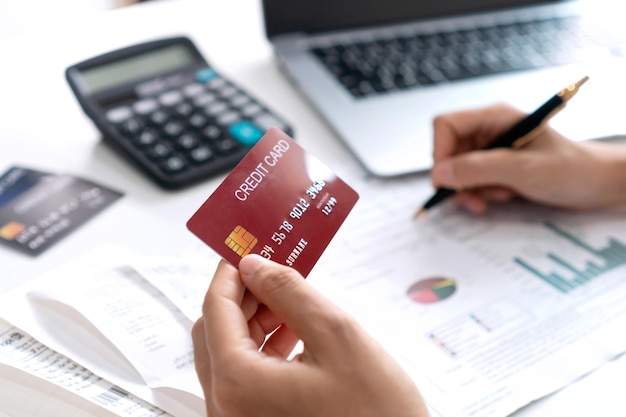 Asian woman checking bills, bank account balance and calculating credit card expenses. Family expenses , business and finance concept