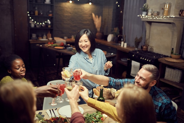 Photo asian woman clinking glasses with friends