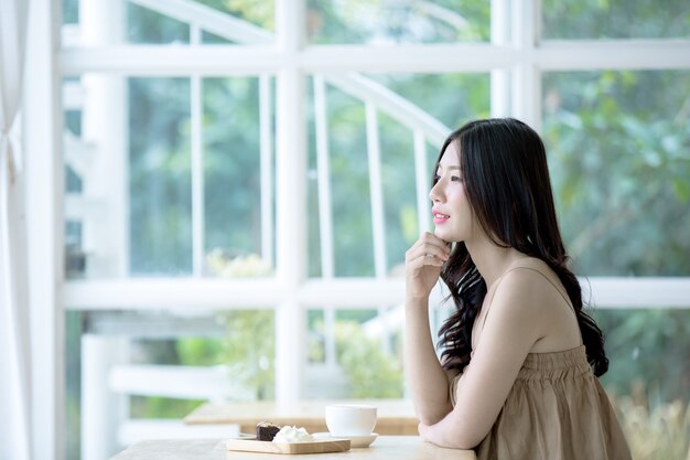 Asian woman coffee at in a cafe drinking coffee