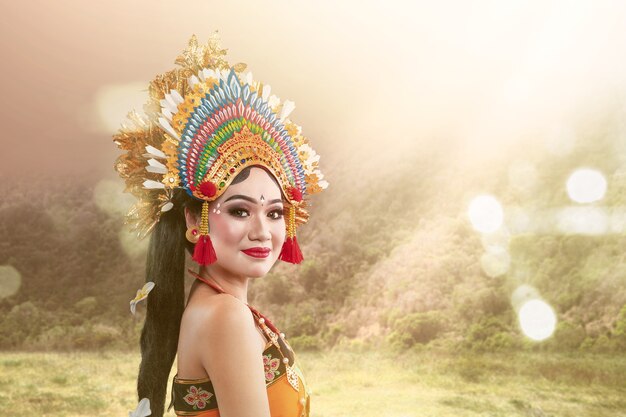 Asian woman dancing Balinese traditional dance with sunlight