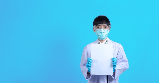 Asian woman doctor holding a blank paper in hand and copy space and she wear medical glove