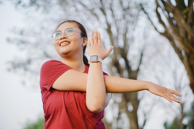 Asian woman doing gymnastics and exercising outdoors excitedly