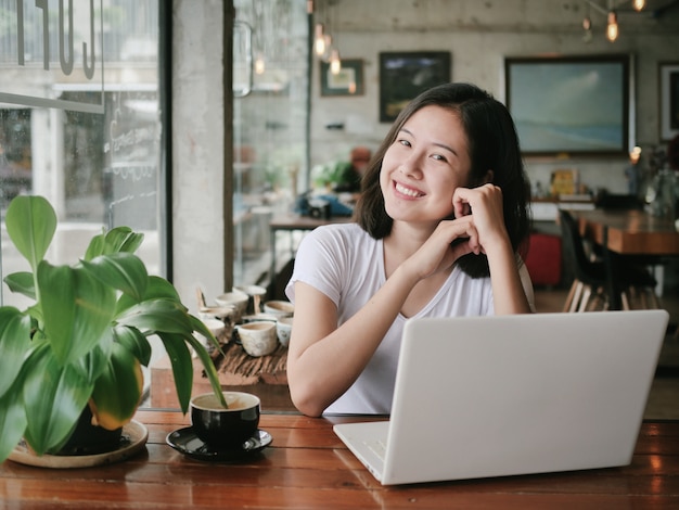 Asian woman drinking coffee and relax in coffee shop cafe