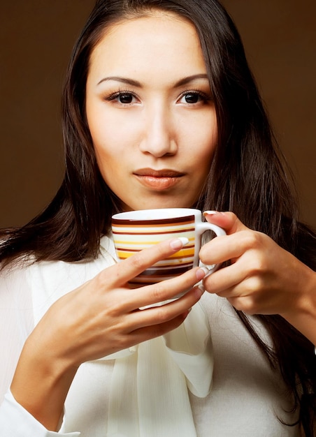 Asian woman drinking coffee or tea