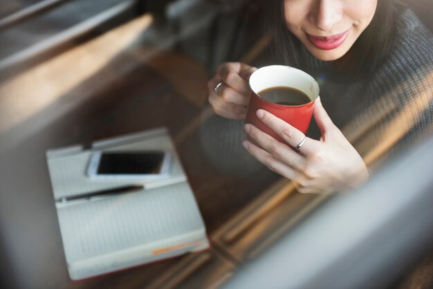 Asian woman drinking coffee