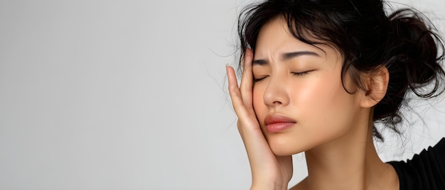 Photo asian woman experiencing trigeminal neuralgia and touching her cheek on white background concept health medical condition trigeminal neuralgia pain management support system