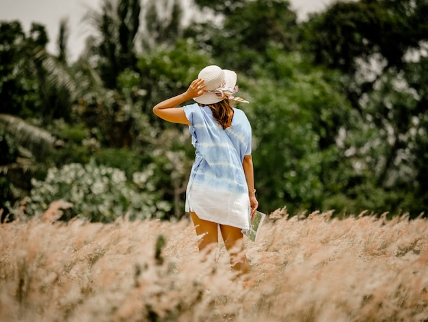 Asian woman on the field with map travel concept