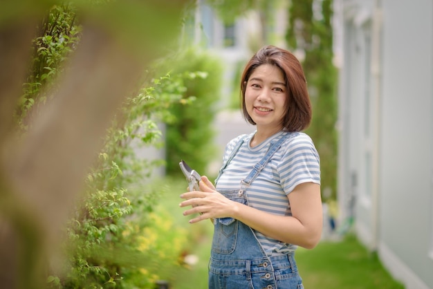 An Asian woman gardener portrait with a pruner