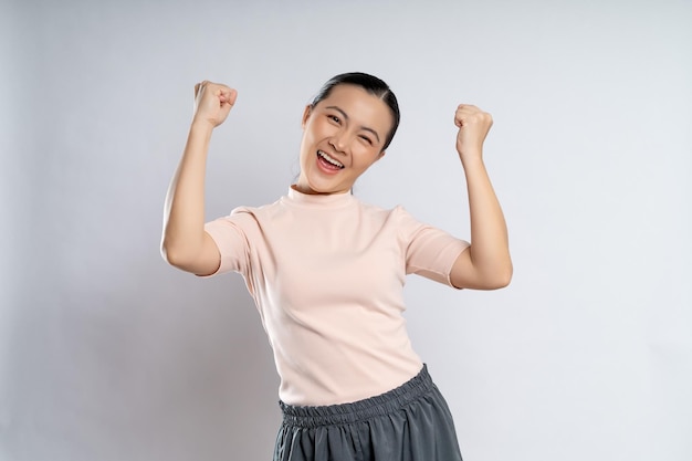 Asian woman happy confident showing her fist make a winning gesture