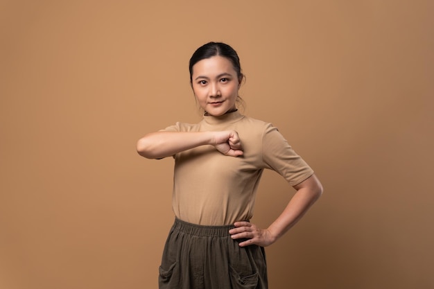 Asian woman happy confident showing a trust standing isolated on beige background