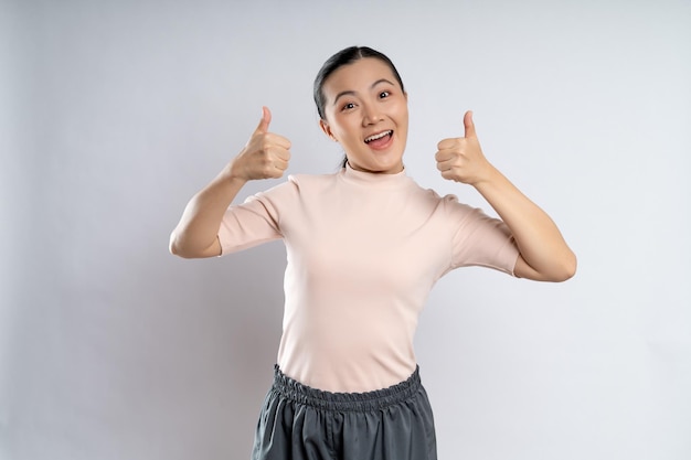 Asian woman happy showing thumb up standing isolated on white background