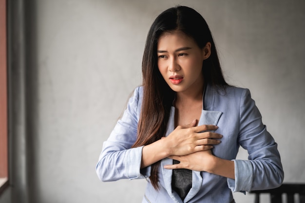 Asian woman have a cold and symptoms coughing, fever, headache and pains