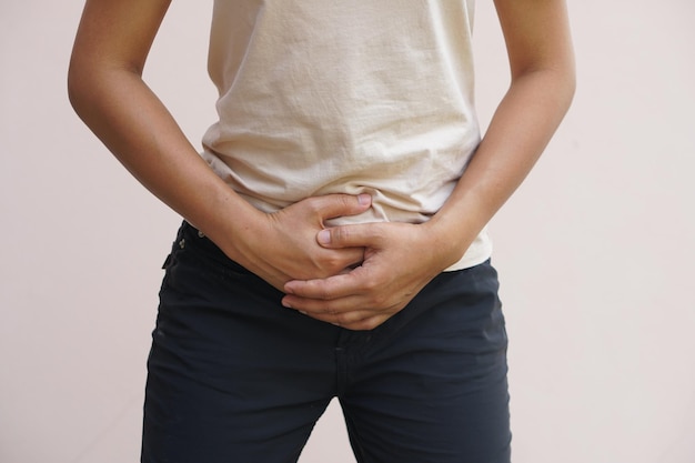 Asian woman having abdominal pain from not eating on time