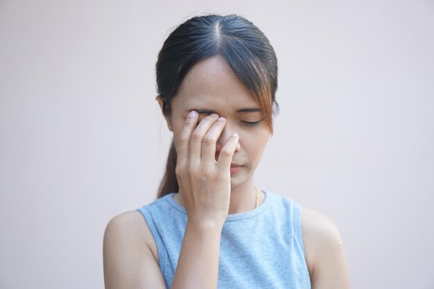 Asian woman having pain in the eye area