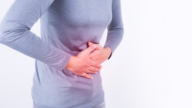 asian woman having stomachache on white background