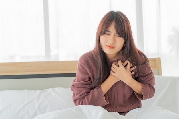 Asian woman Heart disease on bed