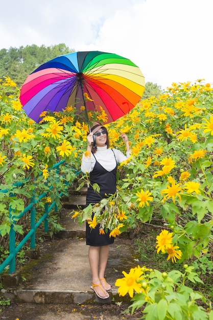 Asian woman hold multicolor umbrella.