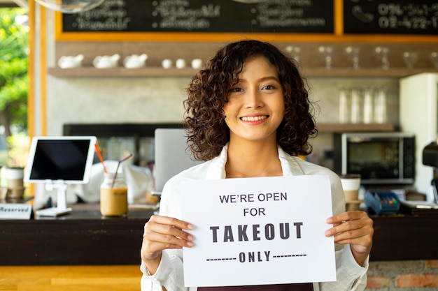 Photo asian woman holding a4 paper for announce to customer