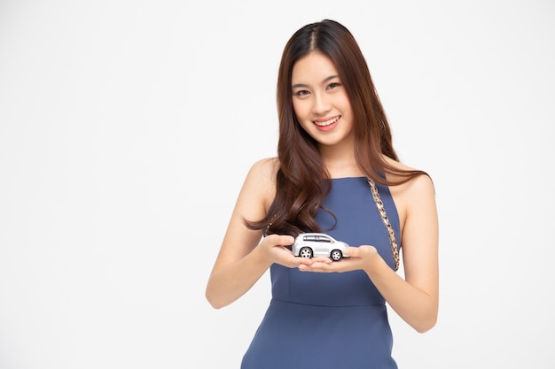 Asian woman holding car model