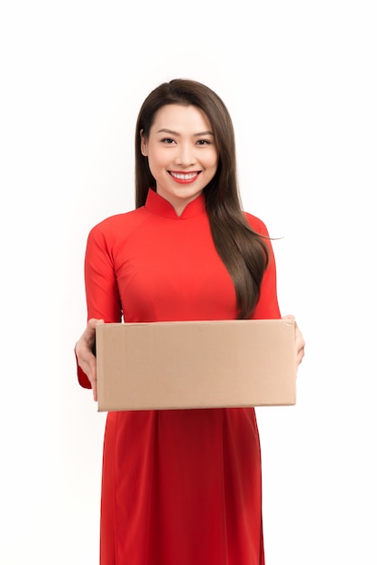 Asian woman holding a gift box in a gesture of giving in spring festival