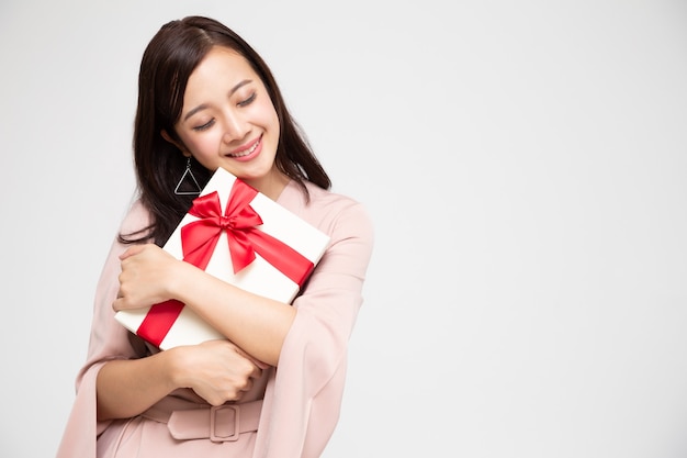 Asian woman holding gift box