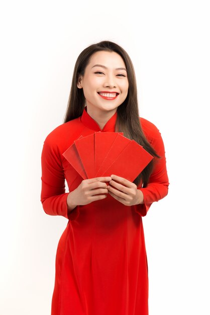 Asian woman holding red envelopes for happy lunar new year, vietnamese tet holiday