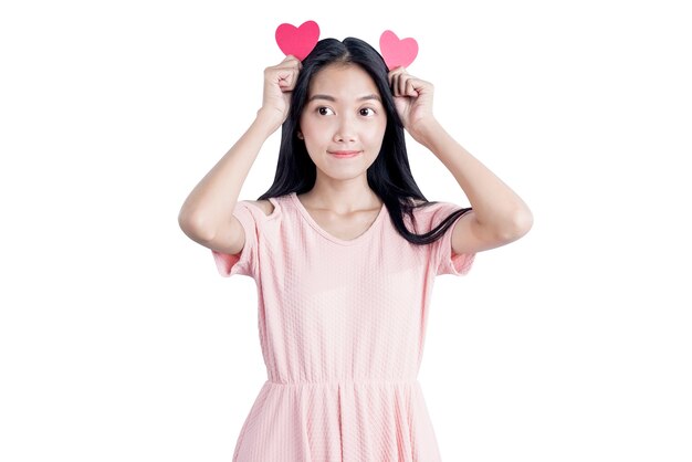 Asian woman holding red hearts isolated over white background